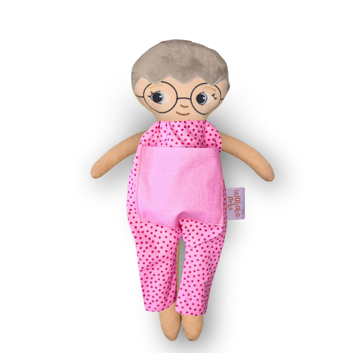 Docka med glasögon, vit hud, grått hår och blå ögon i rosa jumpsuit med rosa ficka
