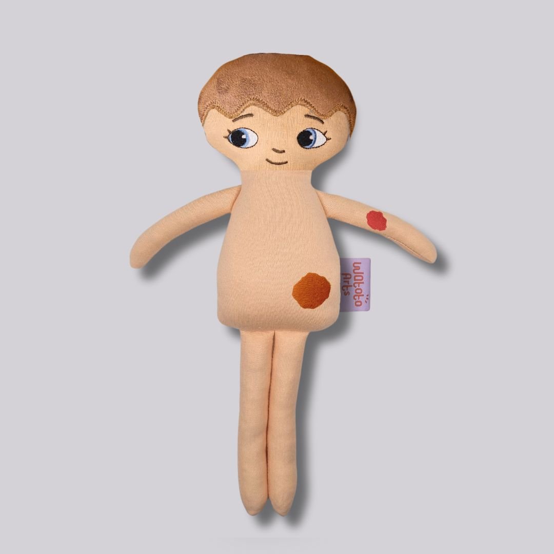 Mjuk docka med smultronmärke eller elds märke - Hemangiom | Watoto Arts
