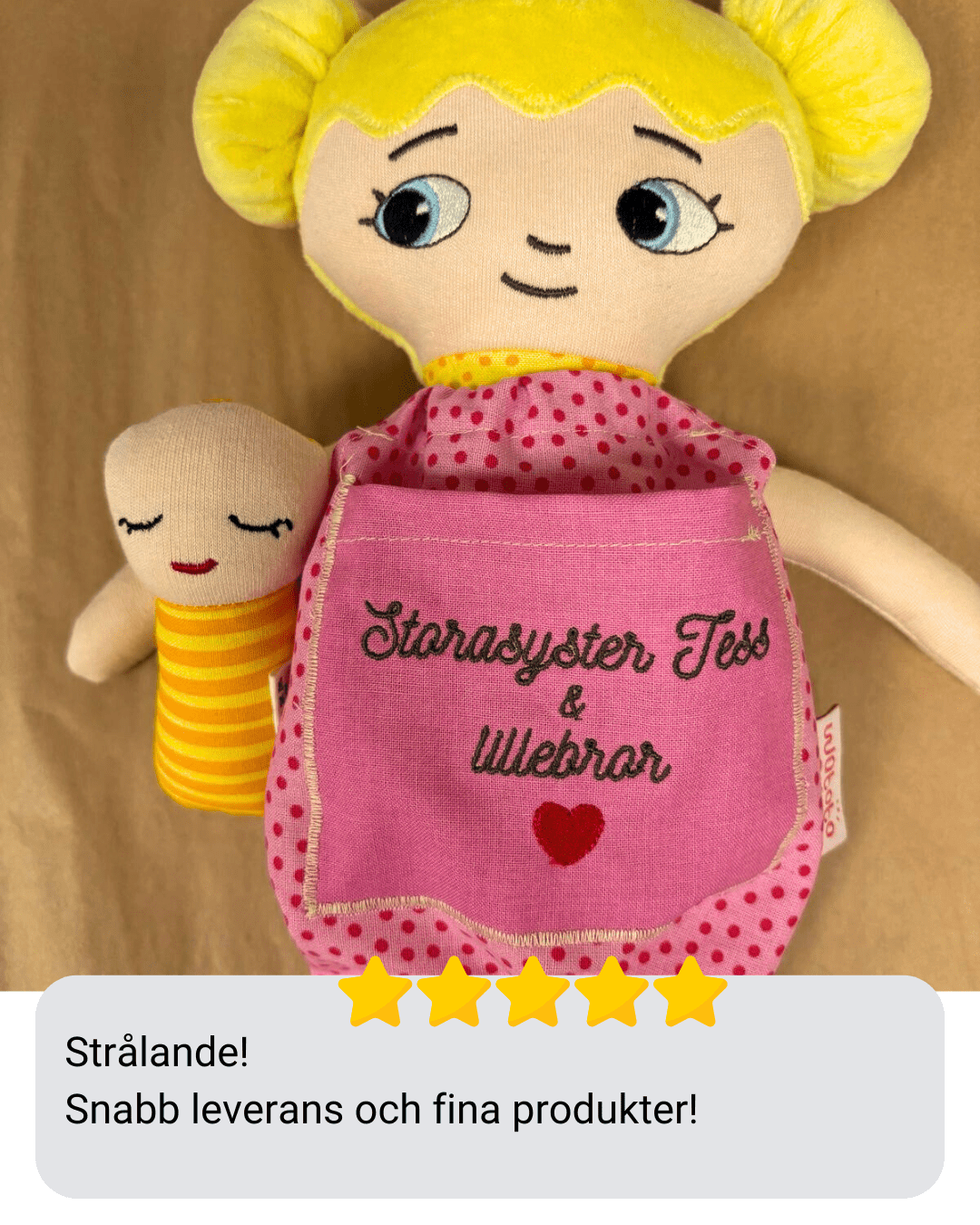 En watoto arts docka med en brodyr och en bebis docka samt en kunds recension